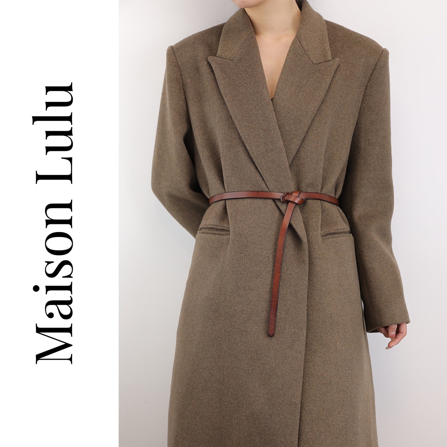 A woman wearing a brown coat with a brown leather knot belt tied around the waist.