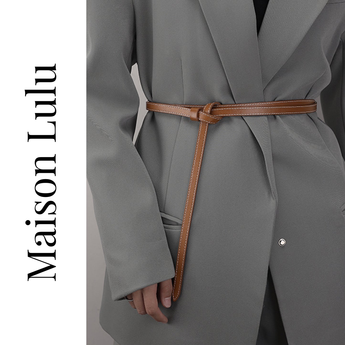 Gray coat with a brown belt and 'Maison Lulu' branding on a white background