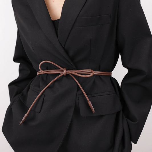 Black coat with a brown belt on a plain background
