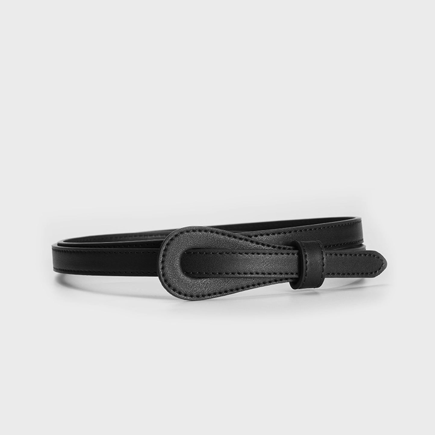 Black leather belt on a light gray background
