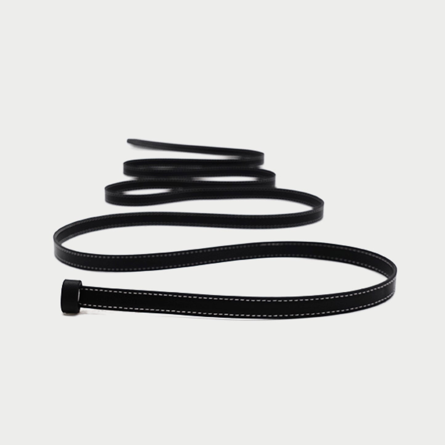 Black leather belt on a light gray background