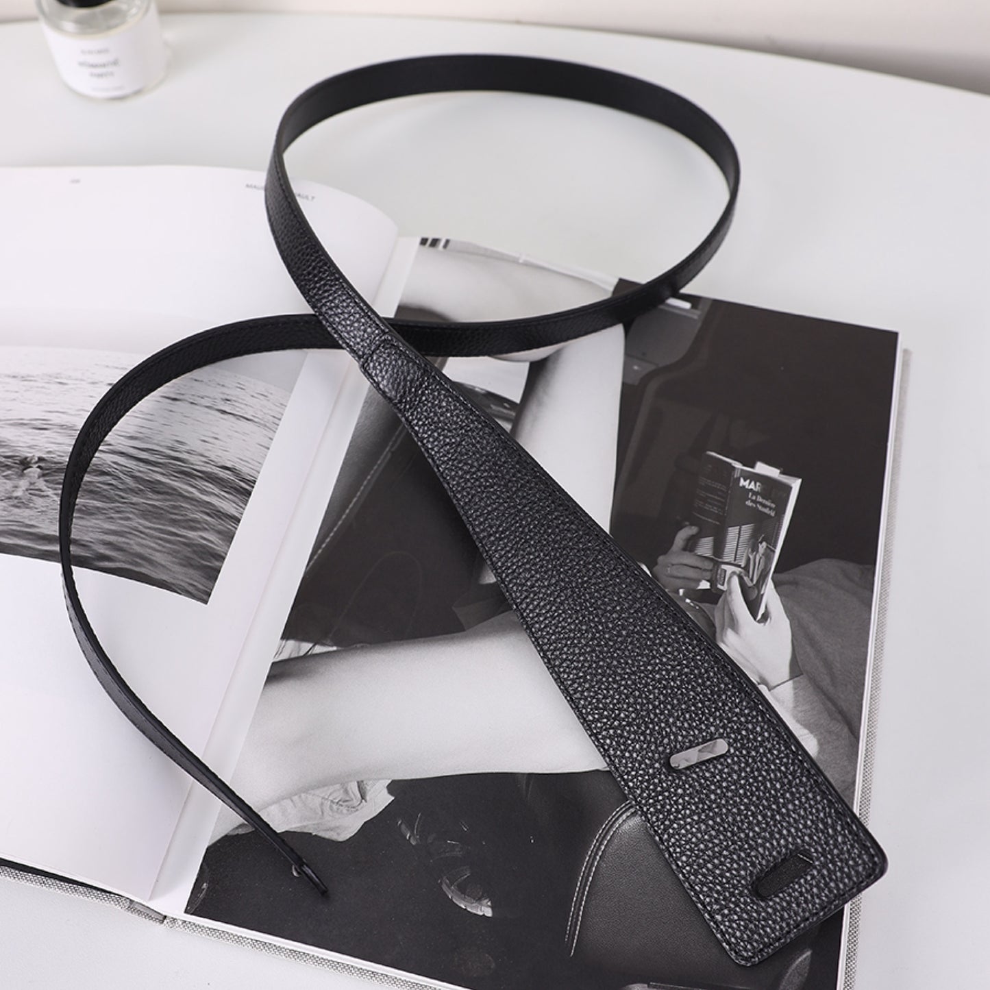 Black leather belt on a magazine with a blurred background
