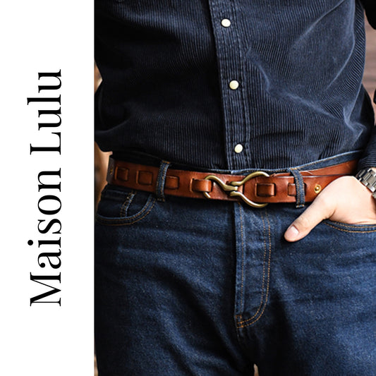 Person wearing a brown belt with a gold buckle, paired with dark blue jeans and a dark shirt, on a white background with 'Maison Lulu' branding.