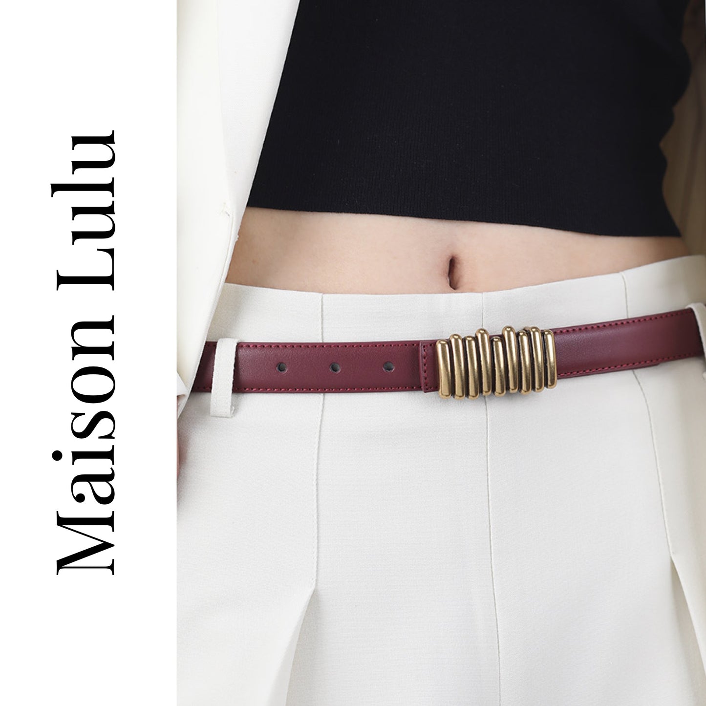Person wearing a burgundy belt with a gold buckle, white pants, and black top, with 'Maison Lulu' branding.