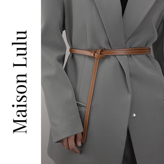 Gray coat with a brown belt and 'Maison Lulu' branding on a white background