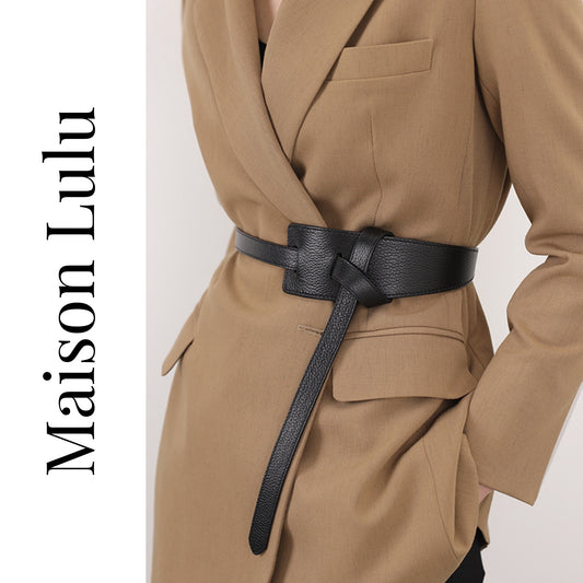 Tan suit with a black belt and 'Maison Lulu' branding on a white background