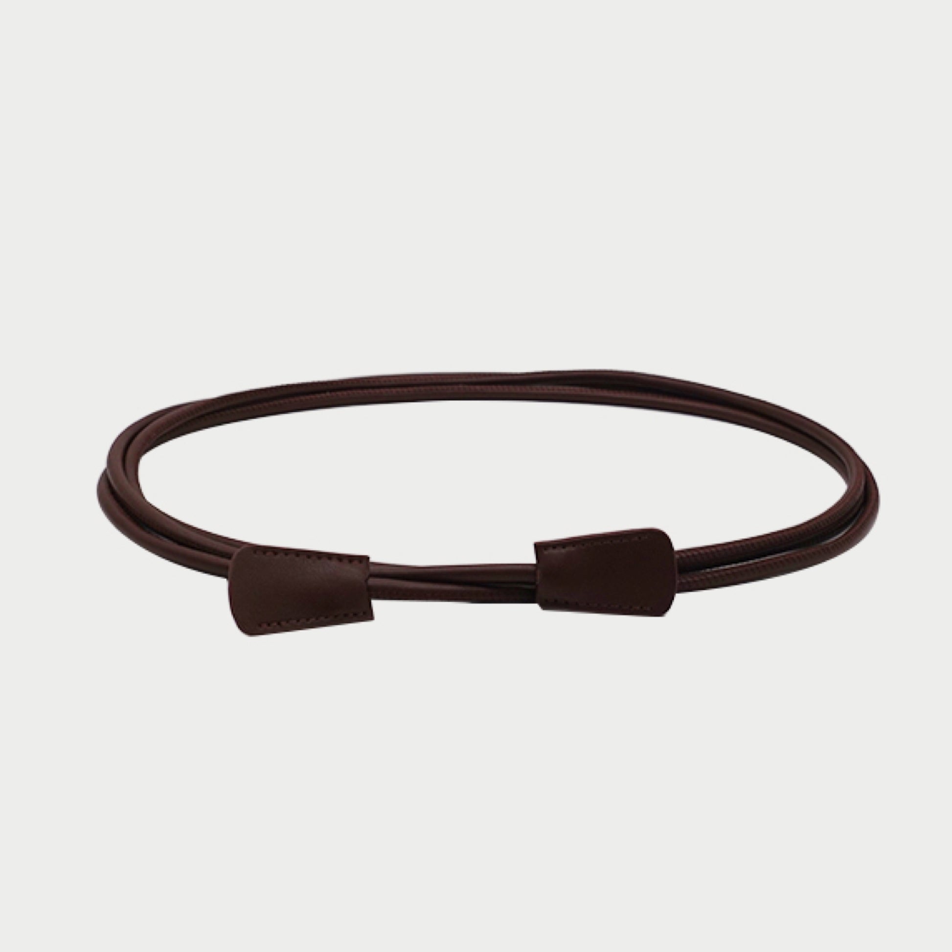Brown leather belt on a light gray background