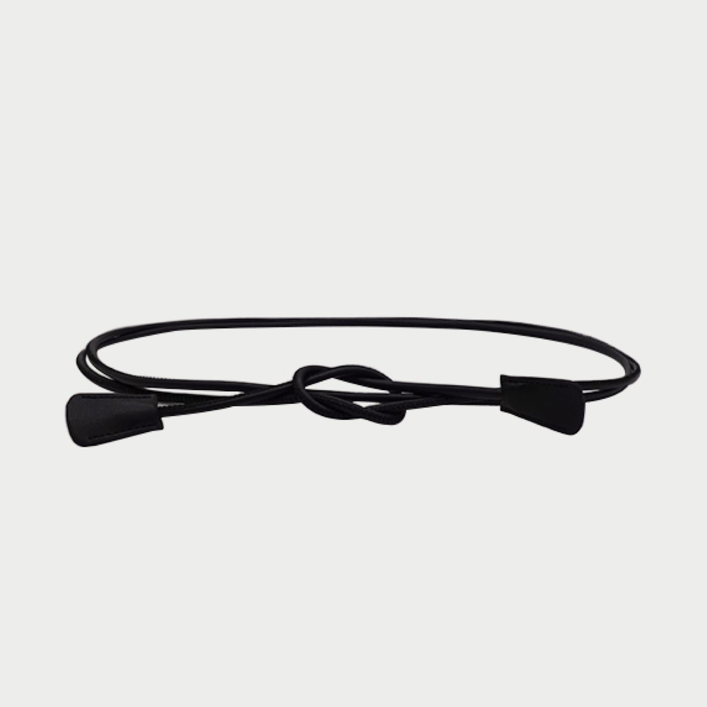 Black belt with a knot on a light gray background