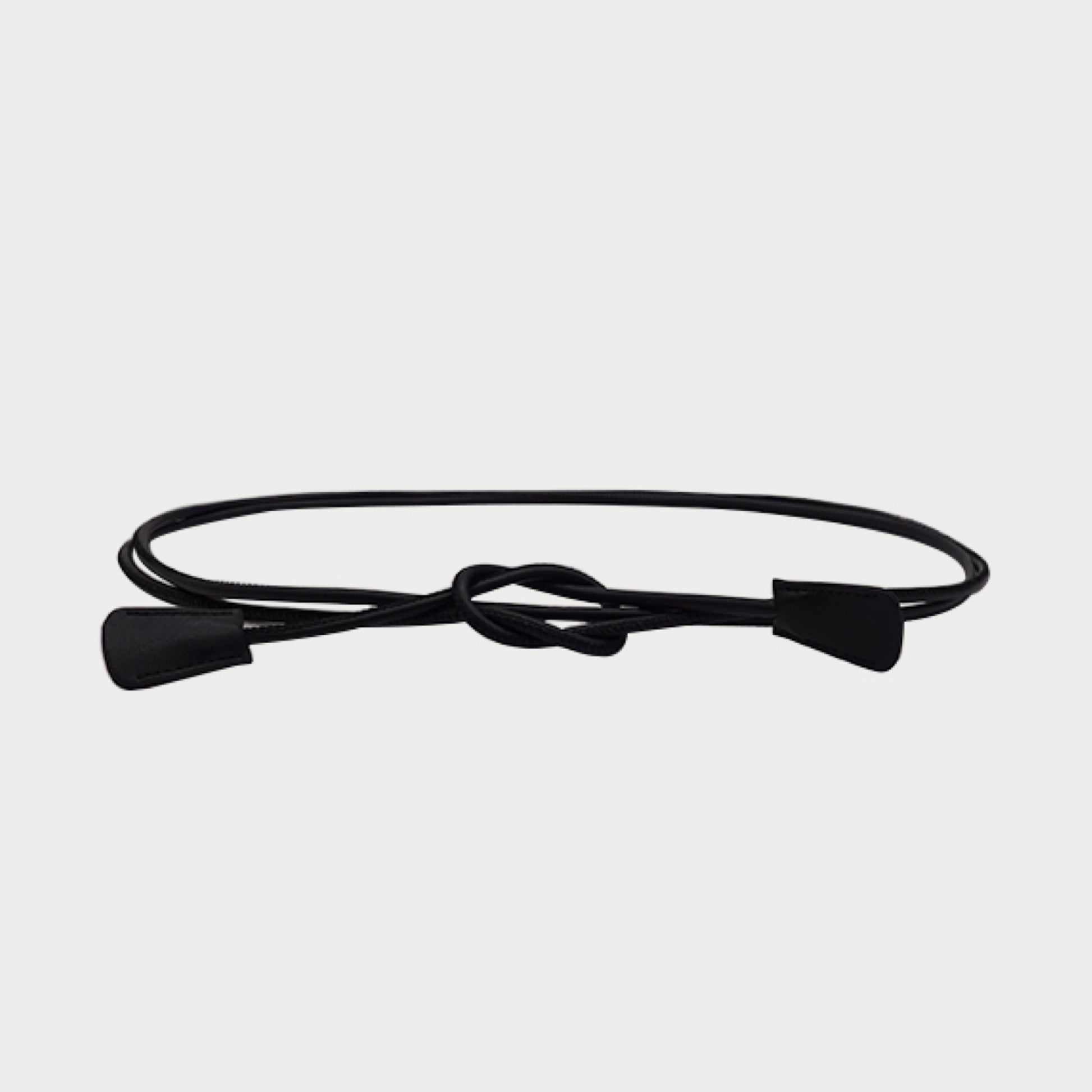Black belt with a knot on a light gray background