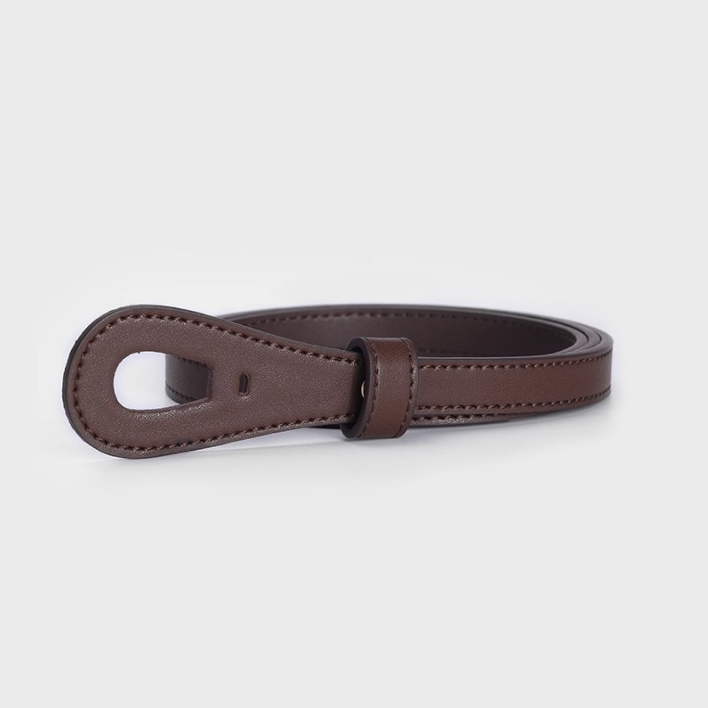 Brown leather belt on a light gray background