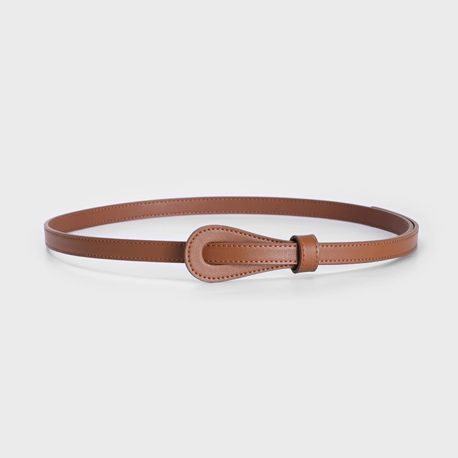 Brown leather belt with a decorative buckle on a light gray background
