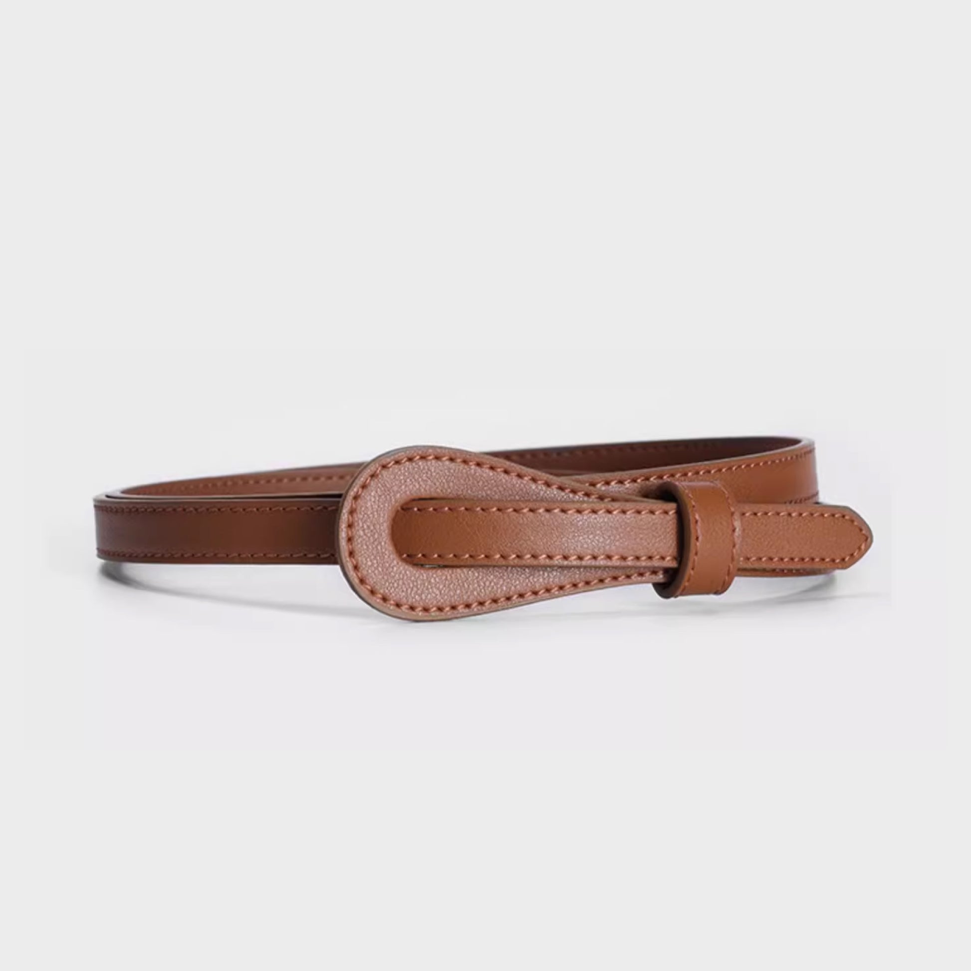 Brown leather belt with a buckle on a light gray background