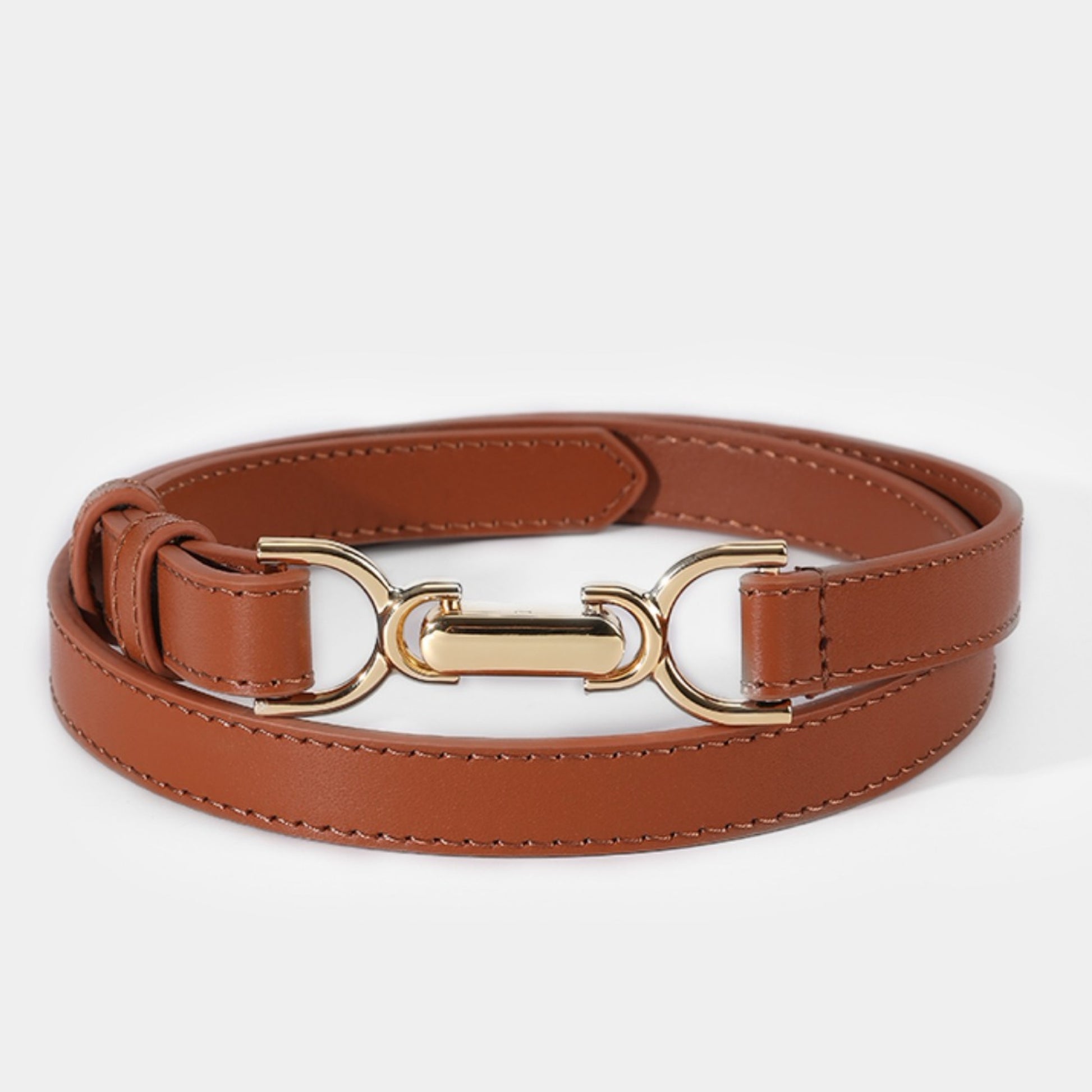 Brown leather belt with a gold buckle on a white background