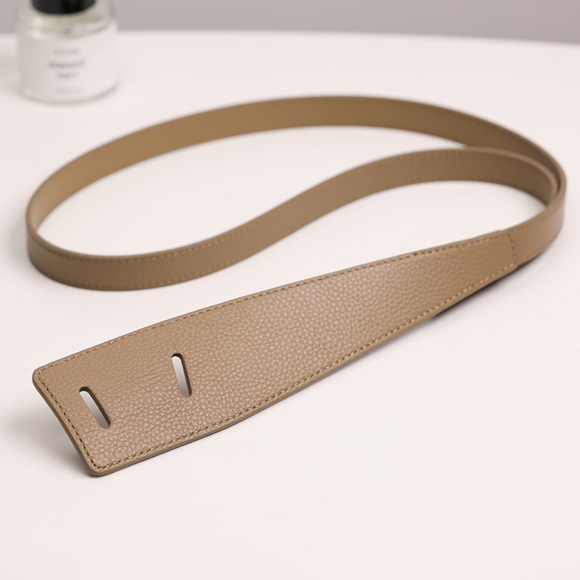 Beige leather strap on a white background