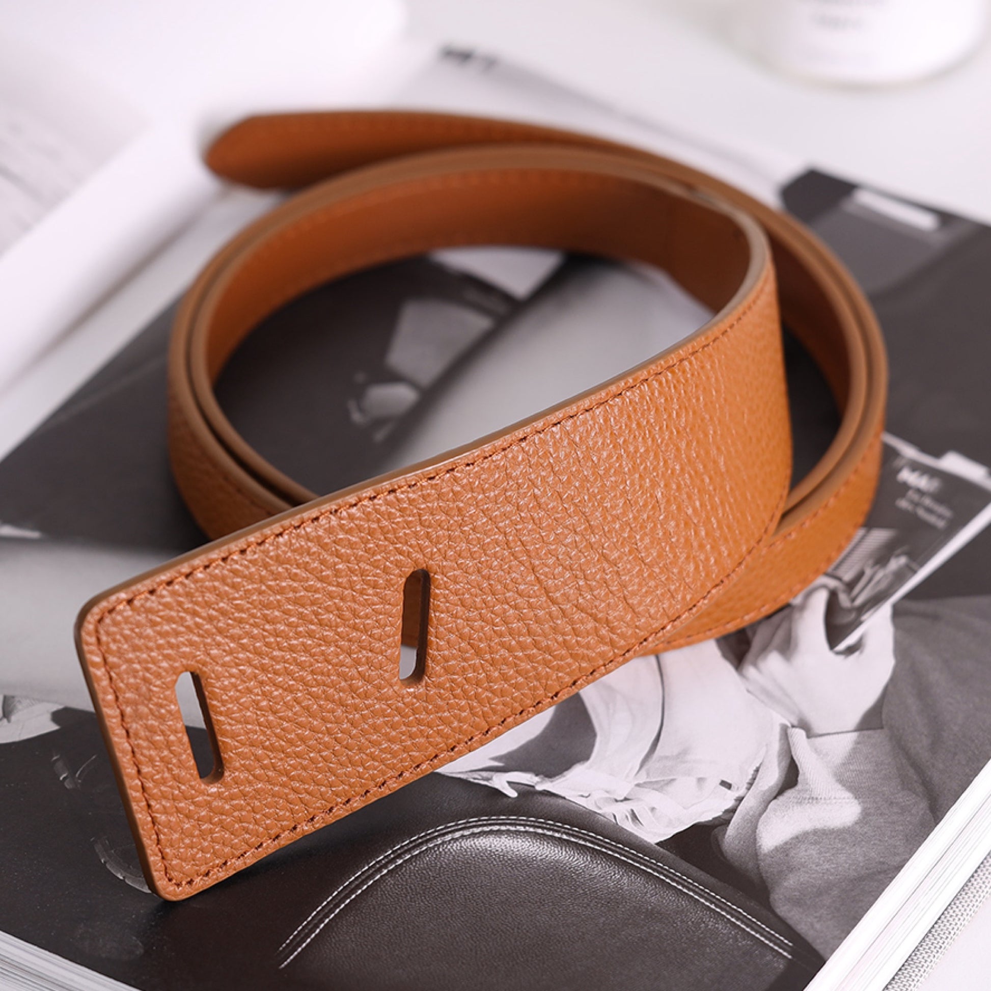 Brown leather belt on a magazine with a blurred background