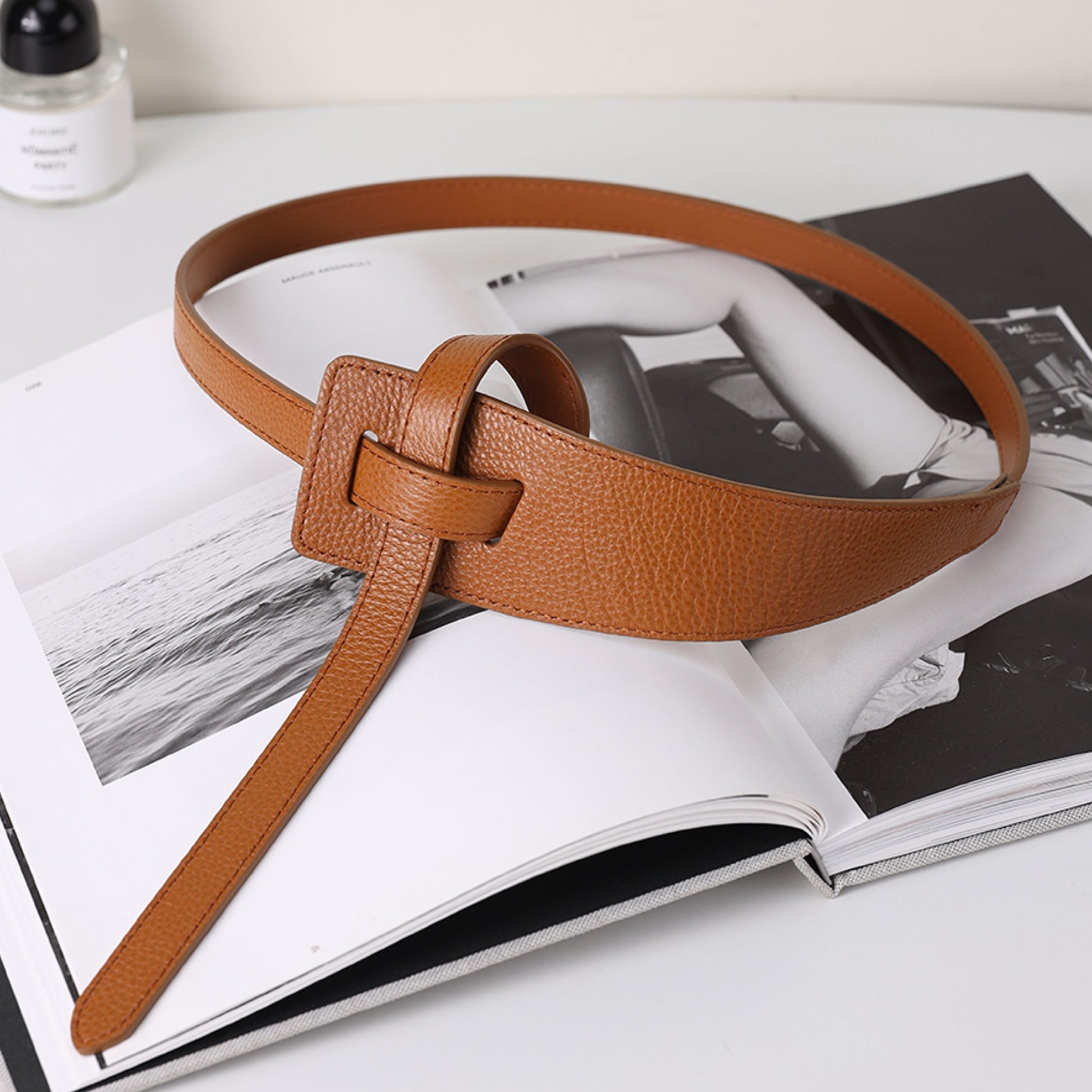 Brown leather belt on an open magazine