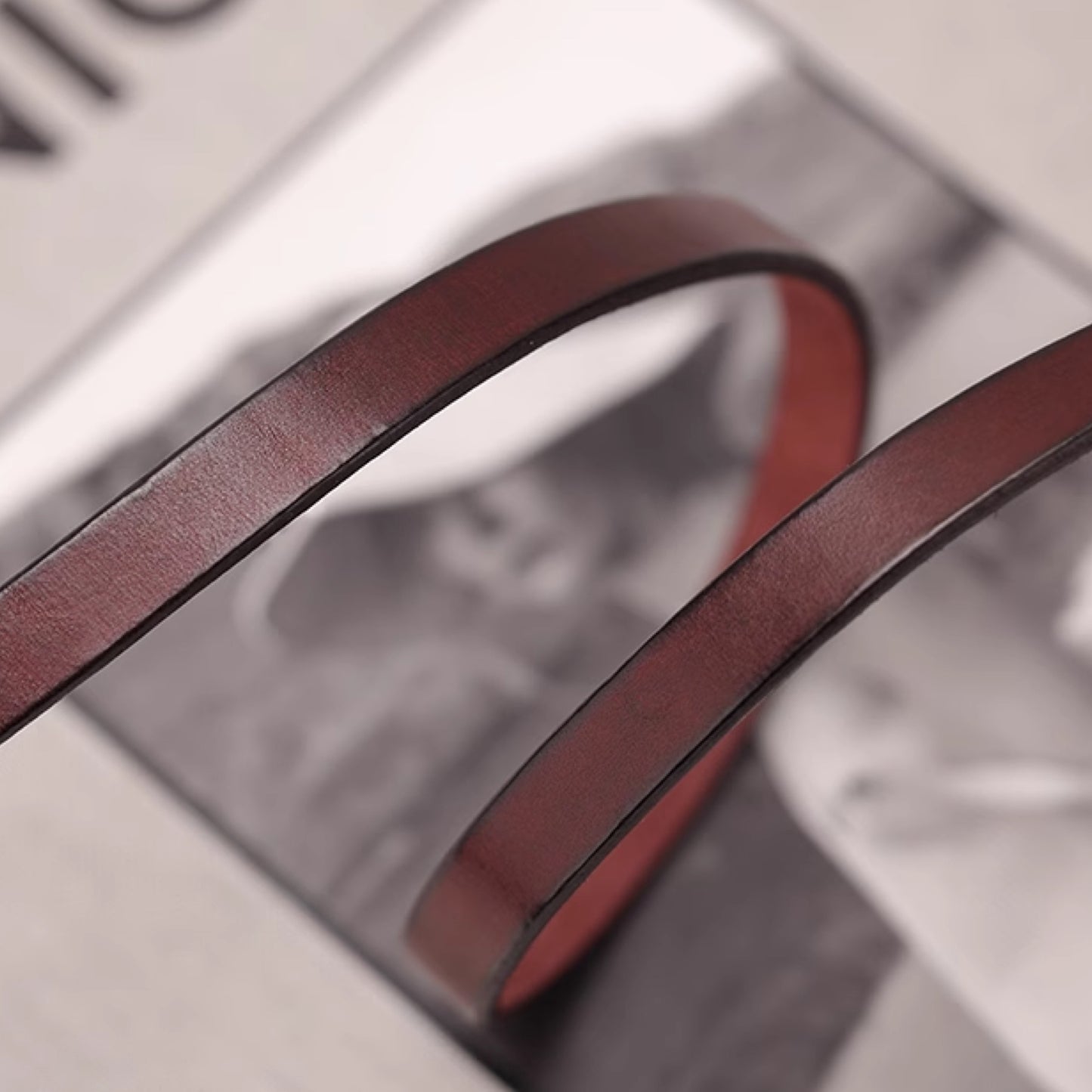 Close-up of a brown leather belt on a blurred background